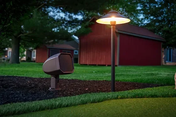 Landscape speaker and path light beside a lawn