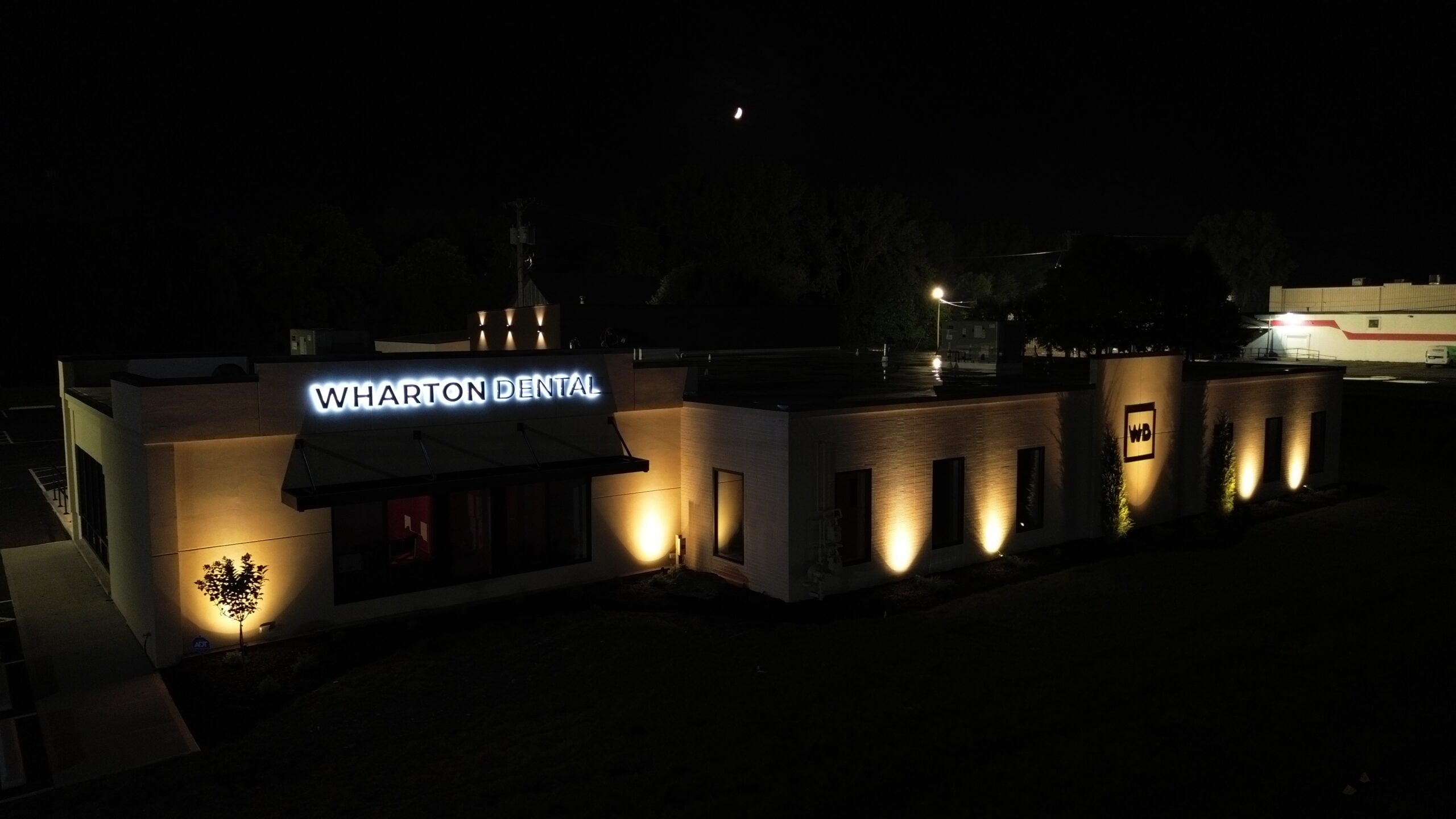 Wharton Dental entrance and illuminated facade at night