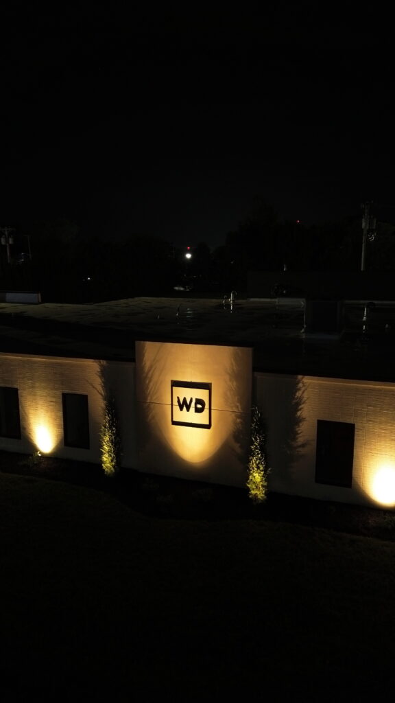 Wharton Dental sign and trees highlighted by warm uplighting